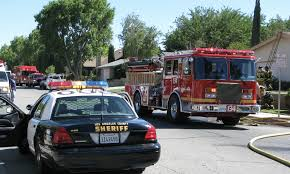 Law enforcement patrol car and fire engine responding together at an emergency scene.